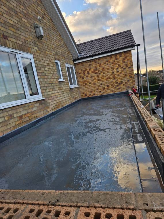 Newly laid GRP roof with a brick parapet on a bungalow extension
