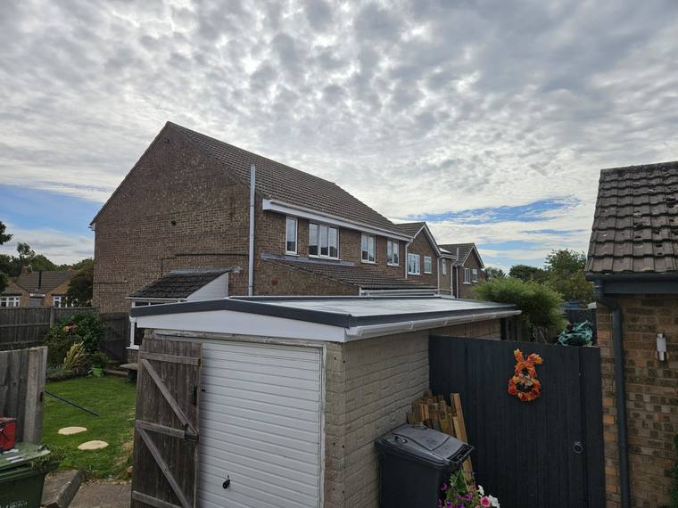 GRP roof on a garage with new white fascia and guttering